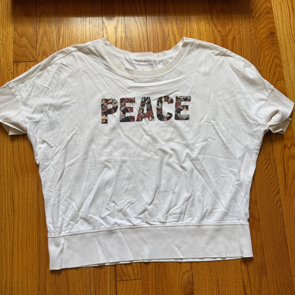 White "peace" Anthropologie short sleeve top with detailing women's medium